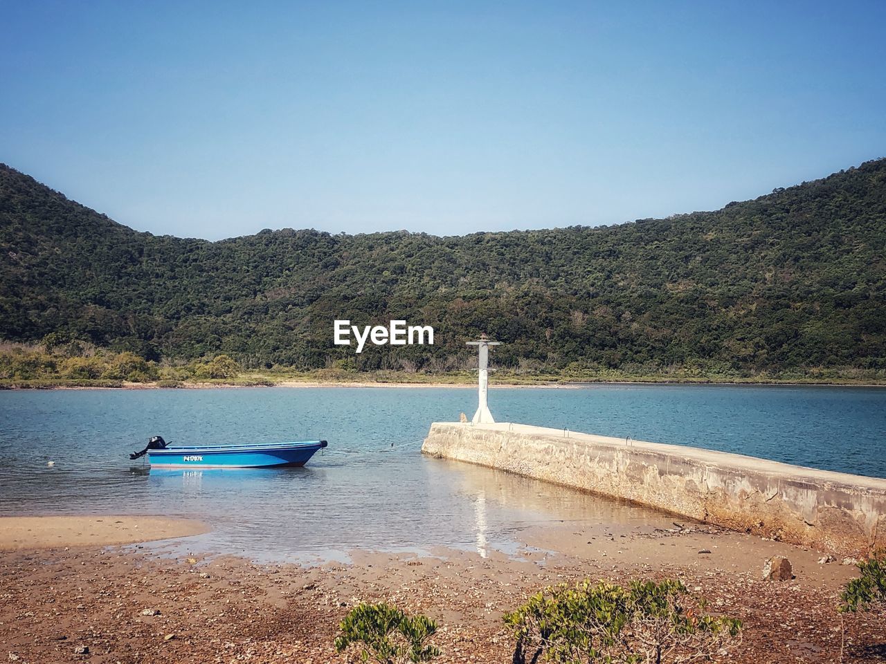 Scenic view of sea against clear blue sky