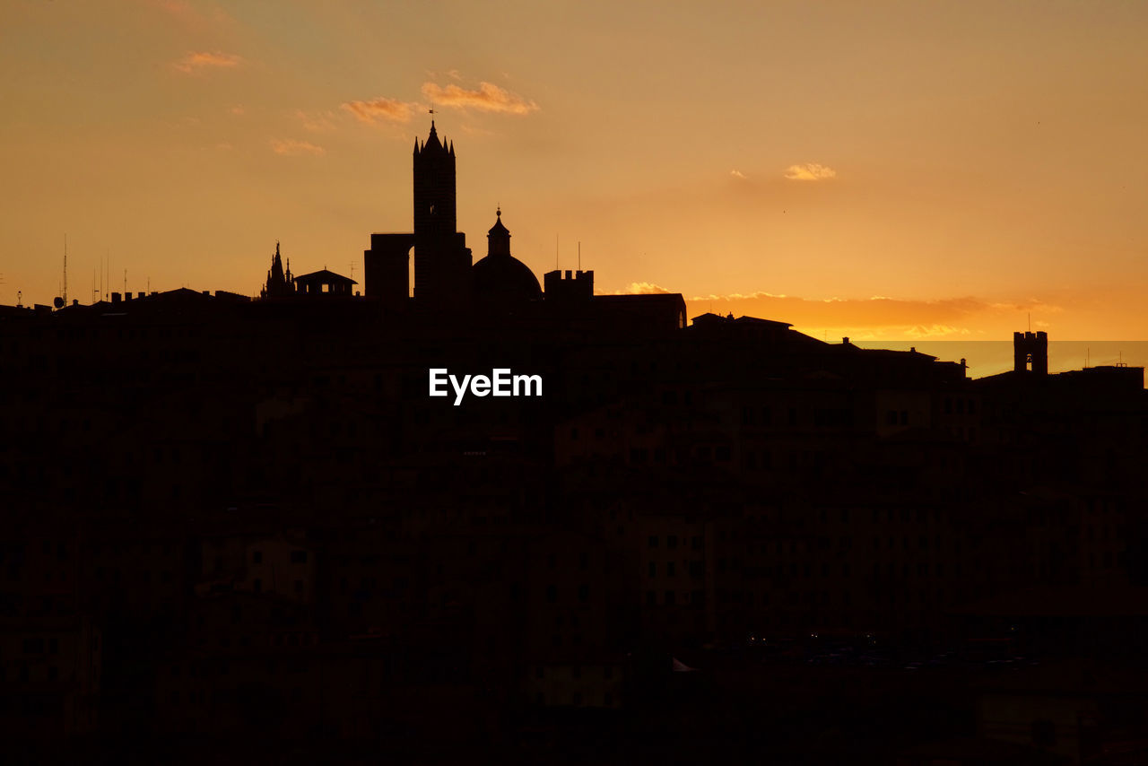 Low angle view of silhouette buildings against sky during sunset