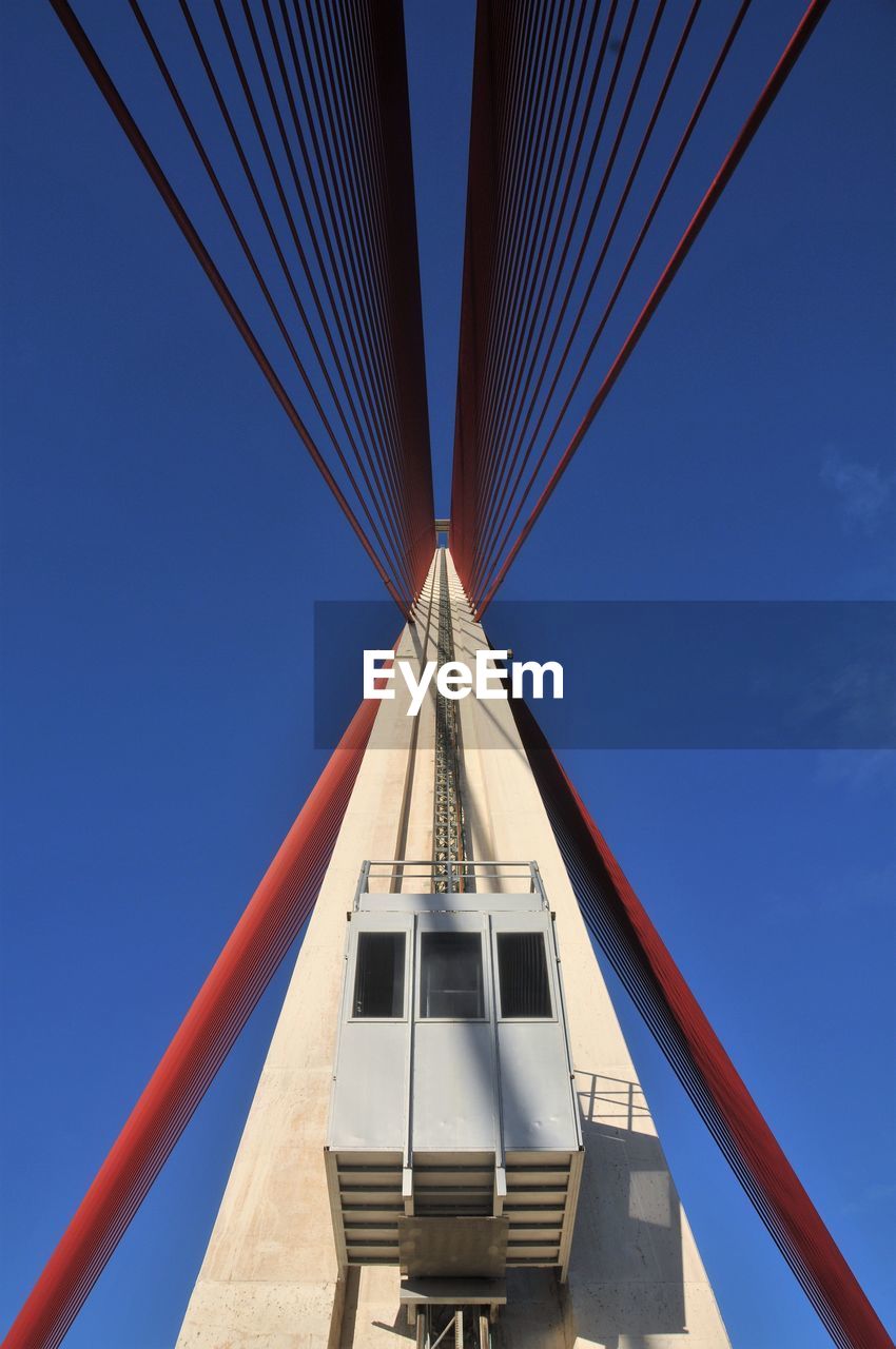 LOW ANGLE VIEW OF SUSPENSION BRIDGE AGAINST SKY