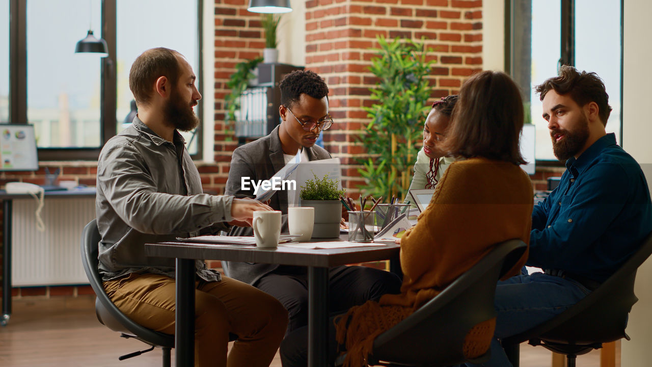 side view of business colleagues working on table