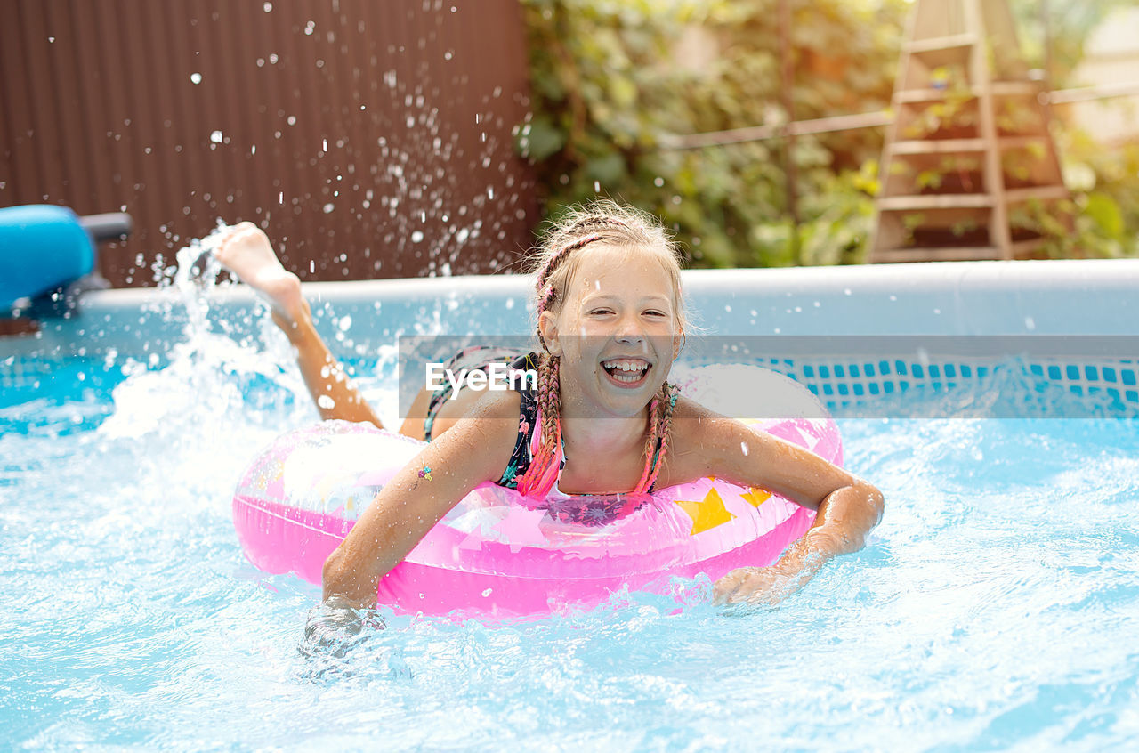 Portrait of boy swimming in pool