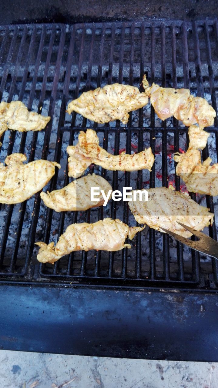 CLOSE-UP OF MEAT ON BARBECUE