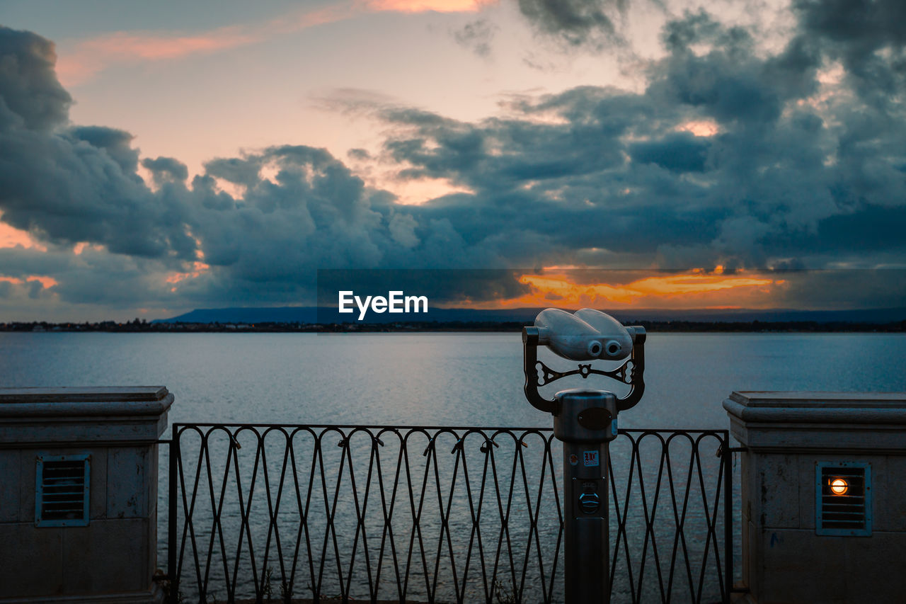 Panoramic sea binoculars with spectacular sunset in the background