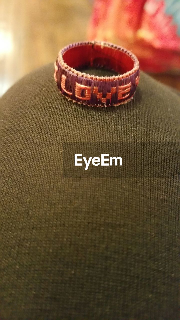 CLOSE-UP OF RED OBJECT ON TABLE