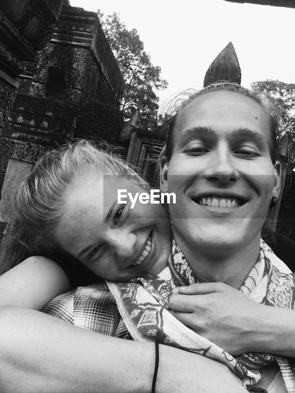 Portrait of smiling woman embracing man