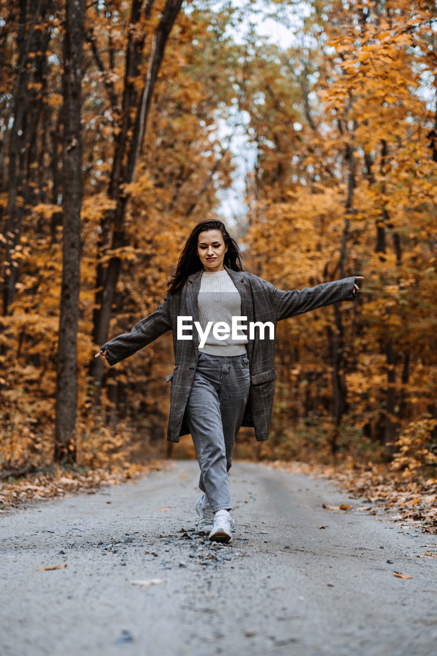 Autumn anxiety, mental health. happy brunette woman enjoy life in autumn forest