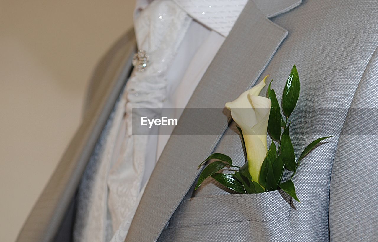 Groom's suit close-up with a bouquet of flowers in his pocket,white shirt