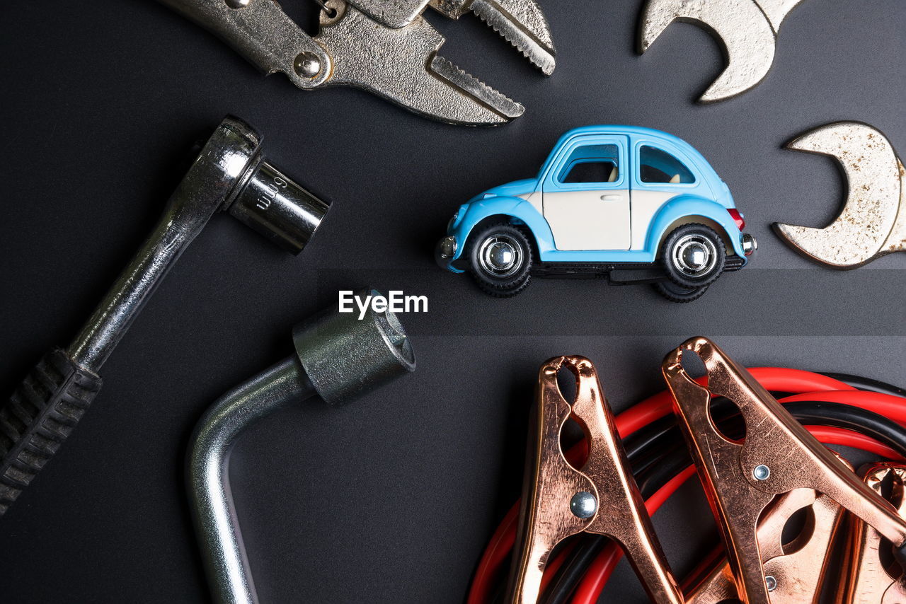 High angle view of toy car with hand tools on table