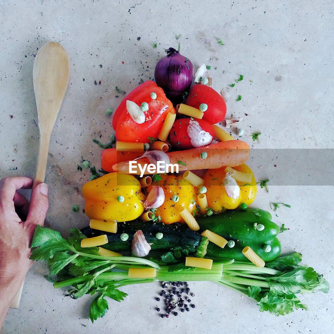 Cropped hand of man arranged food on table