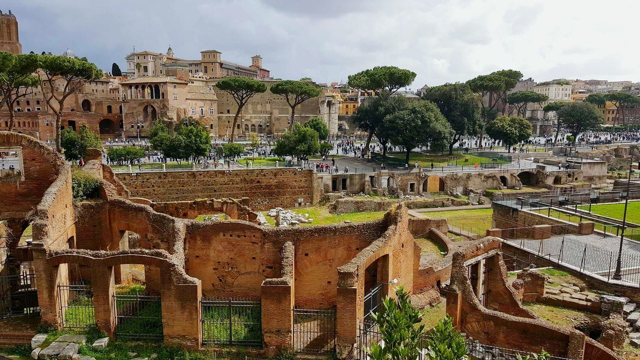 High angle view of old ruins against cloudy sky