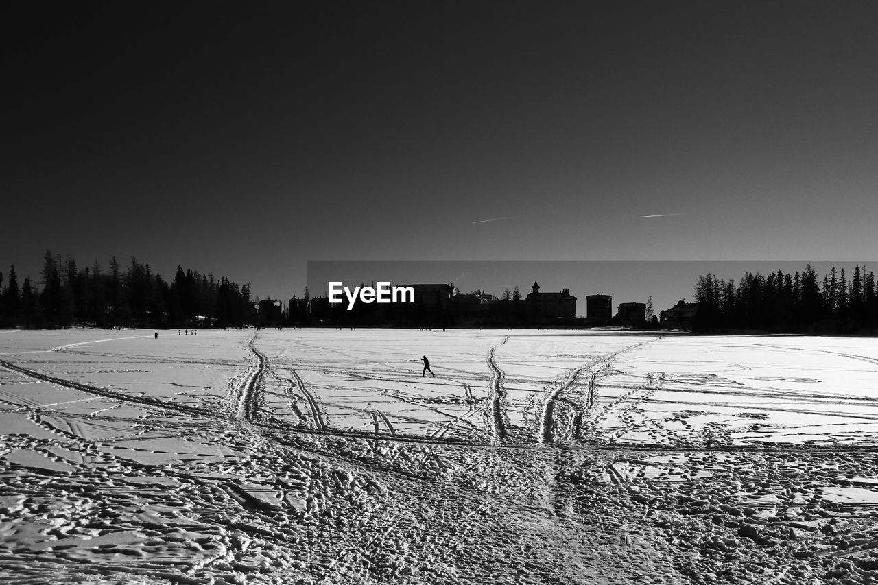 SCENIC VIEW OF SNOW FIELD AGAINST CLEAR SKY