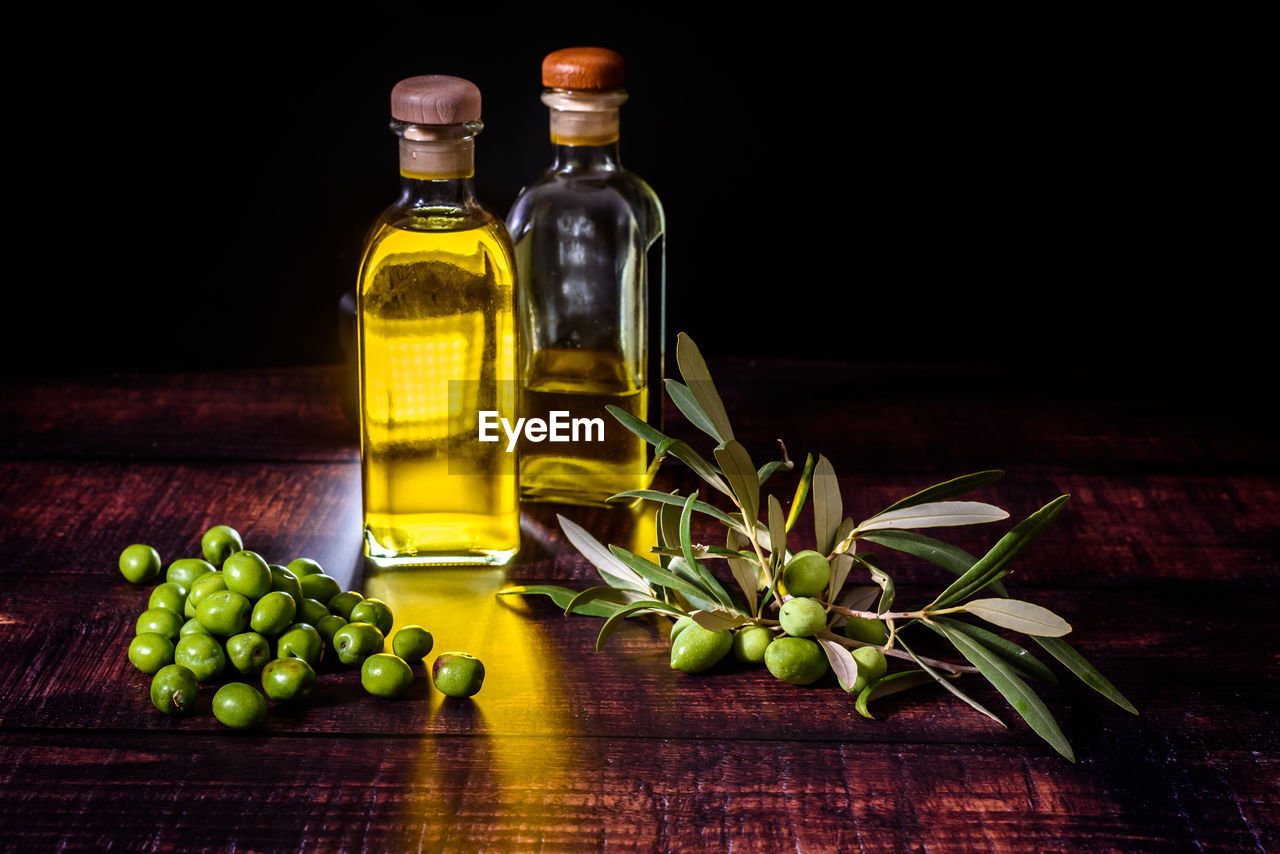 GREEN FRUITS IN GLASS ON TABLE