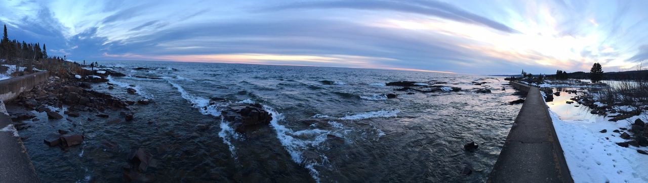 Panoramic view of beach against sky during sunset