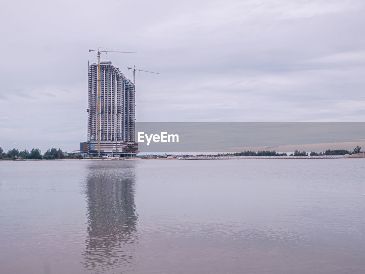 water, architecture, built structure, reflection, sky, tower, cloud, nature, industry, no people, building exterior, sea, outdoors, day, skyline, city, skyscraper, building, horizon, waterfront, travel destinations, business finance and industry, environment, travel, landscape, scenics - nature, beauty in nature, bay