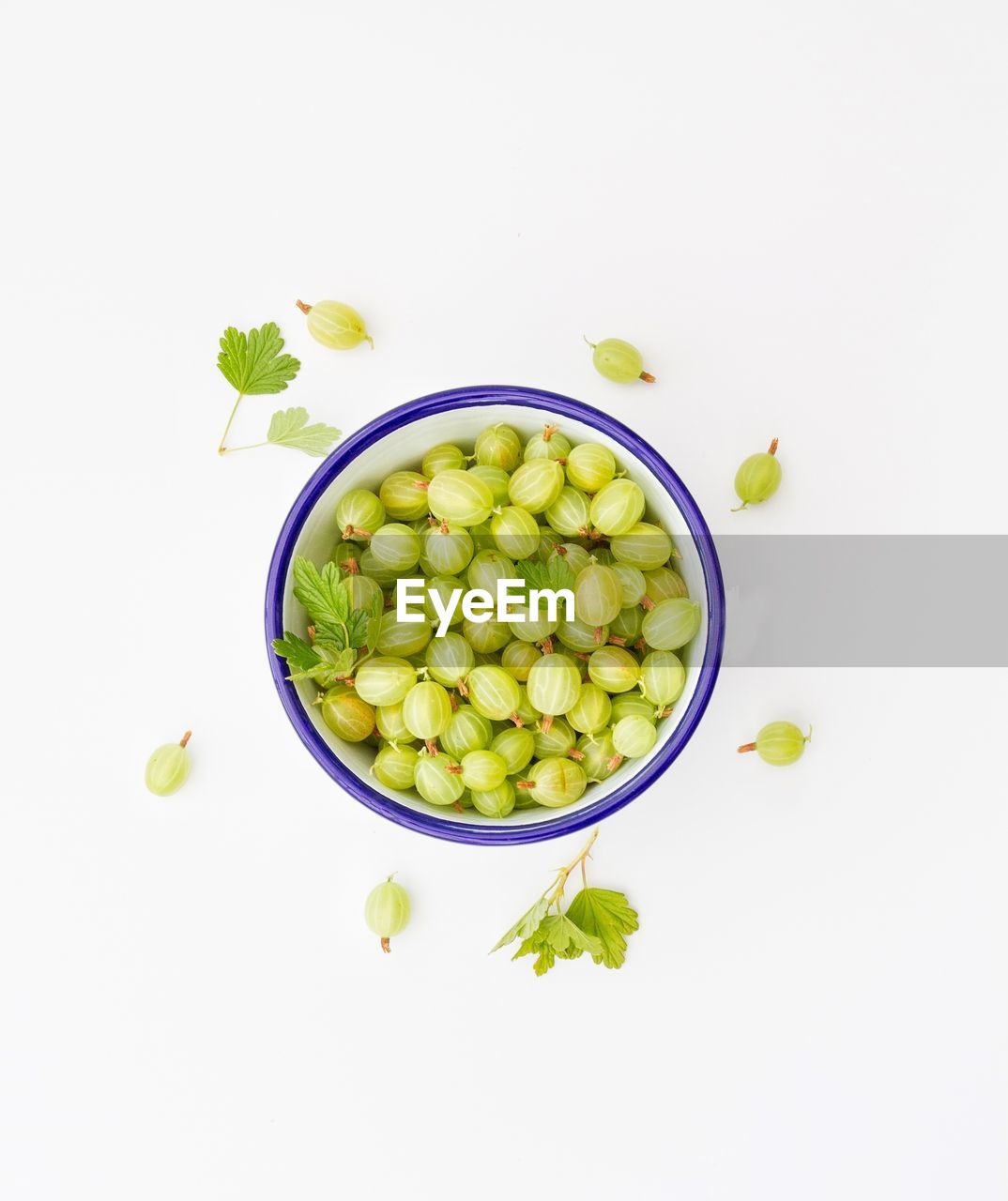 Directly above shot of gooseberries in bowl on white background