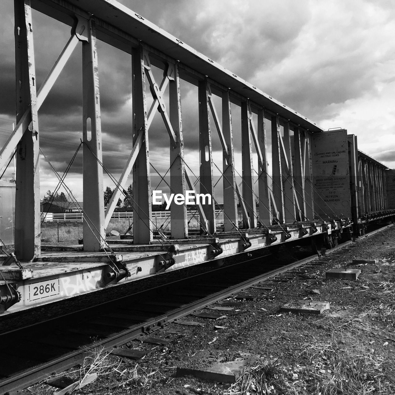 Freight train against cloudy sky