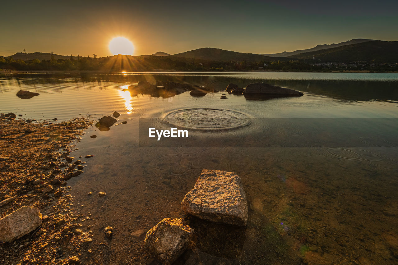 water, sky, reflection, morning, sea, nature, sunrise, scenics - nature, dawn, mountain, beauty in nature, land, environment, coast, sun, landscape, sunlight, shore, tranquility, horizon, no people, beach, travel, travel destinations, outdoors, tranquil scene, cloud, ocean, body of water