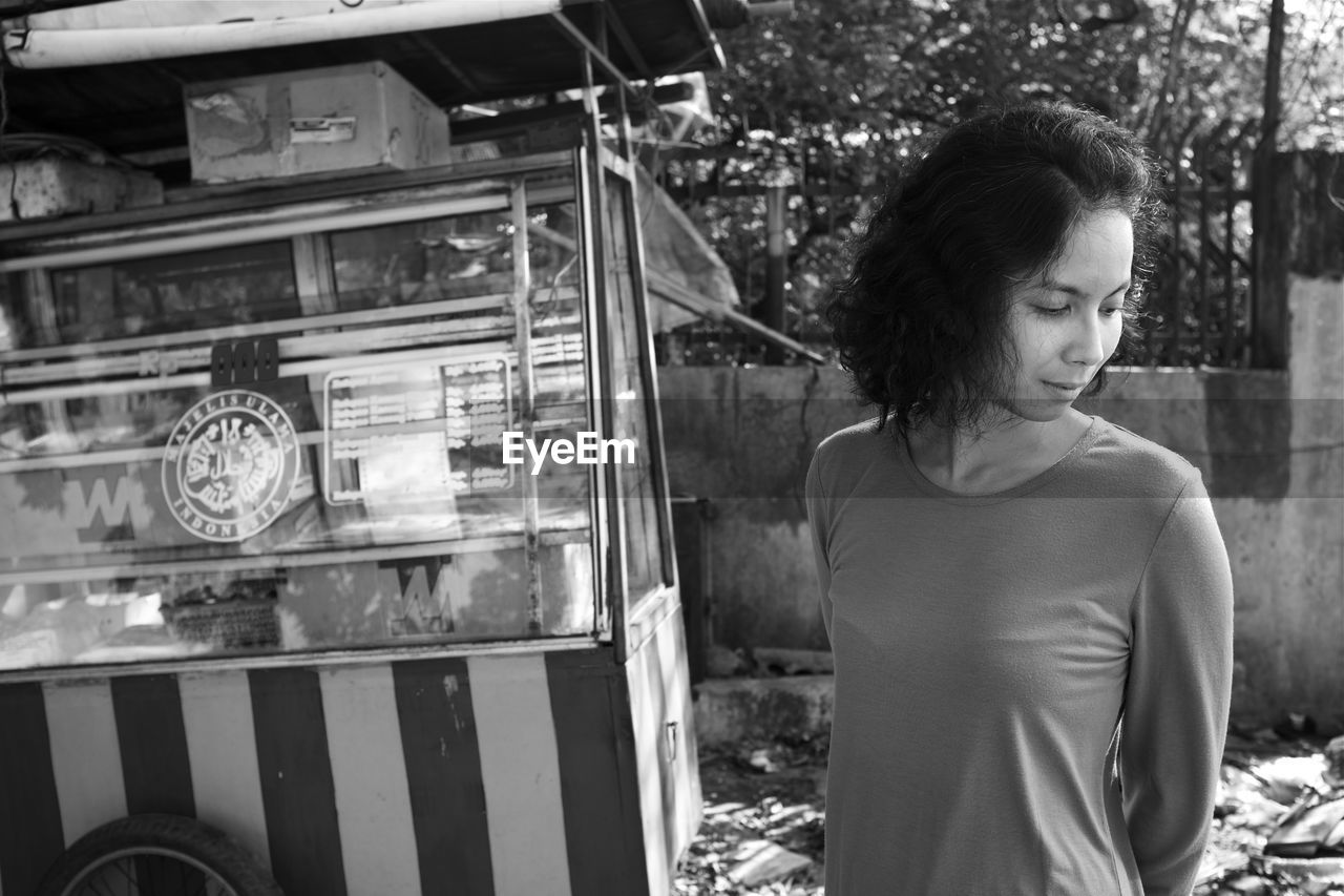 Woman standing by market stall