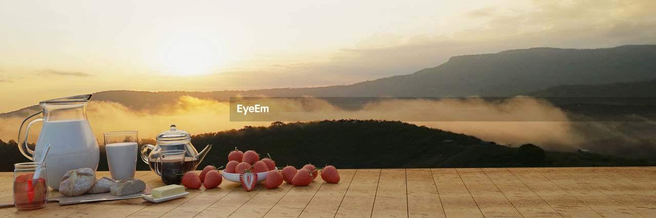 PANORAMIC SHOT OF FOOD ON TABLE DURING SUNSET