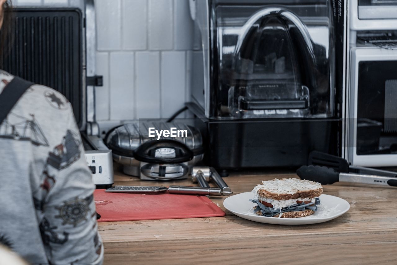 Man in plate on table at home