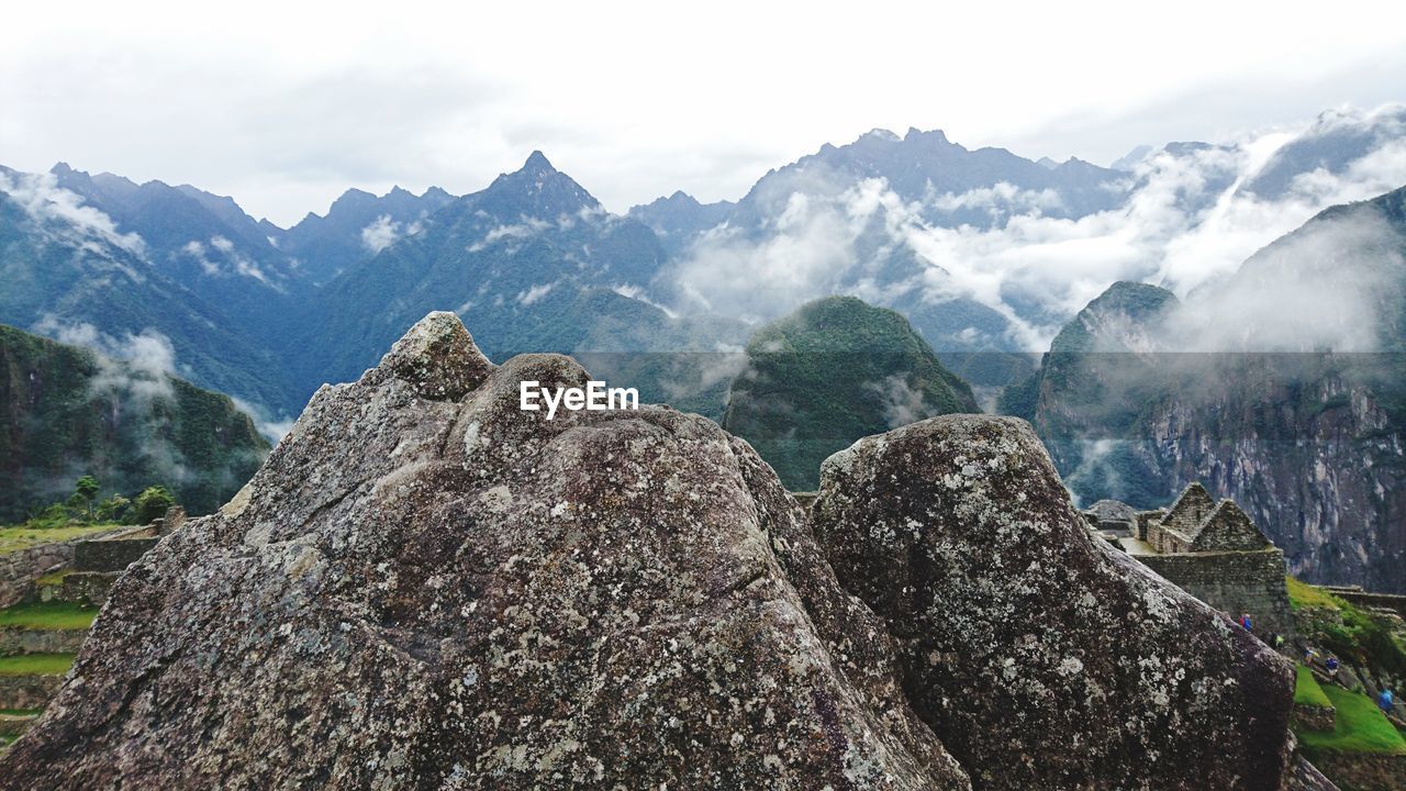 PANORAMIC VIEW OF ROCKS AND MOUNTAINS AGAINST SKY