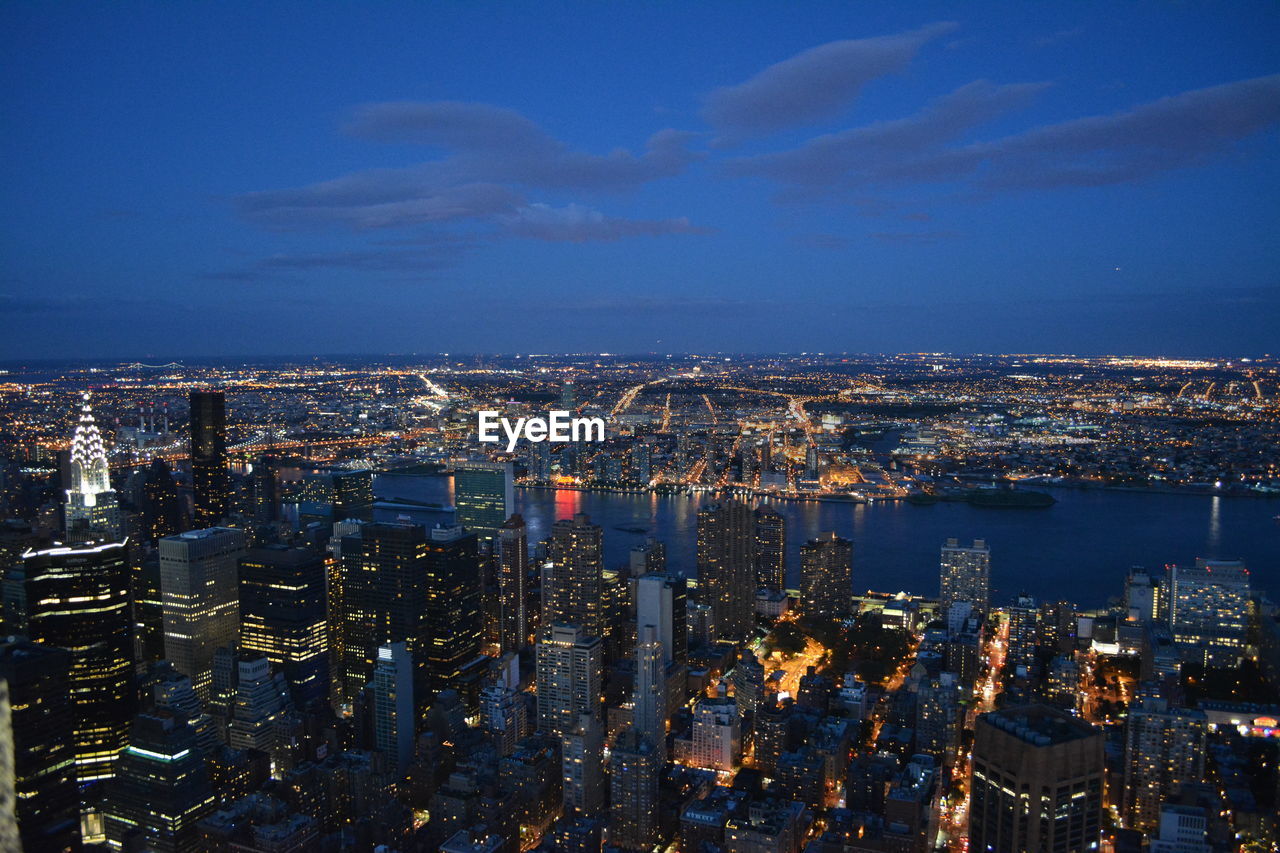 High angle view of city lit up at night