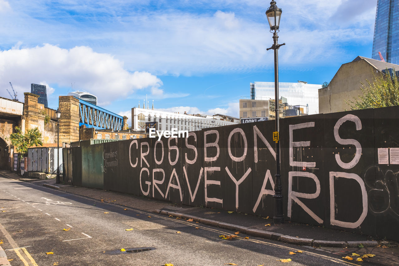 GRAFFITI ON ROAD AGAINST SKY