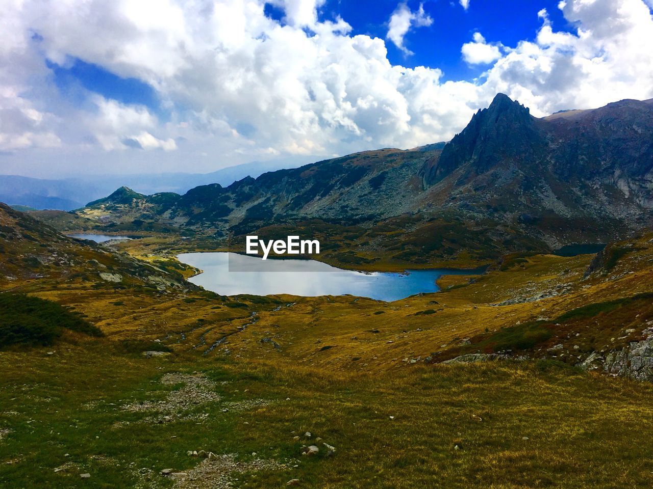 Scenic view of lake surrounded by mountain