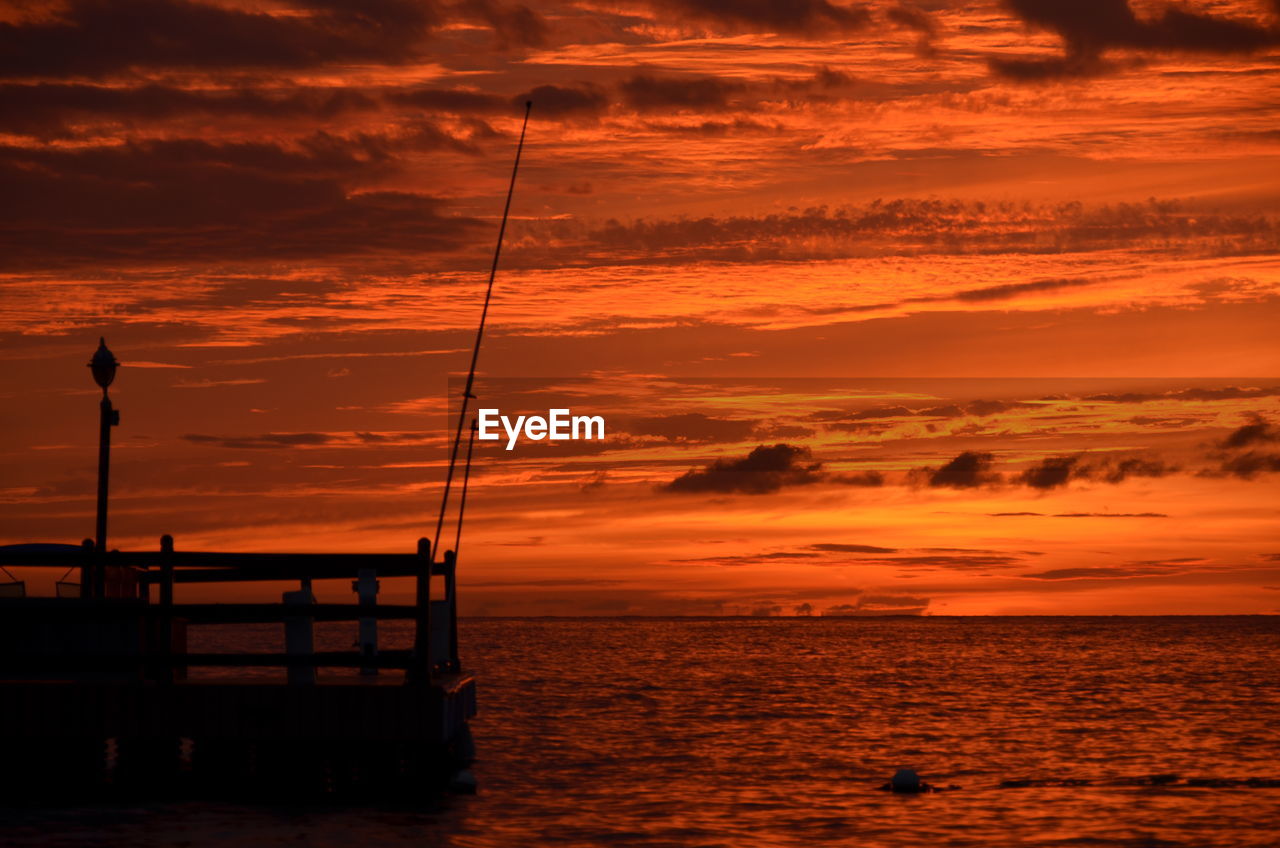 Scenic view of sea against orange sky