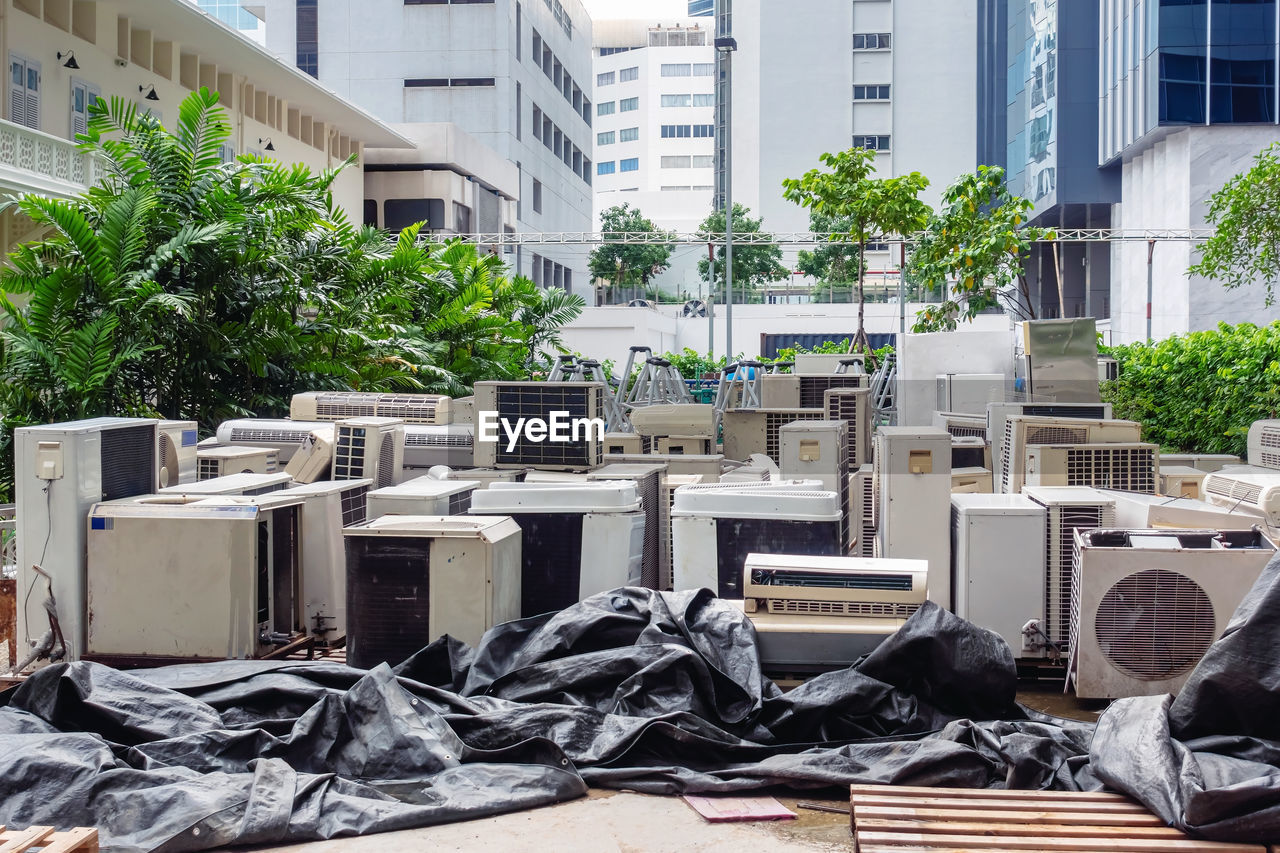 A lot of air conditioners stacked up in a pile to disposal at recycling garbage dump. 