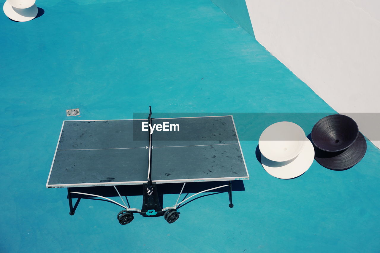 High angle view of empty table tennis at court during sunny day