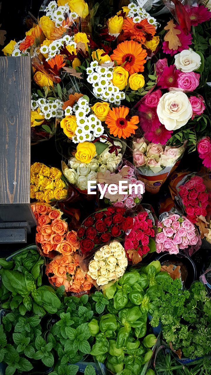 Stack of flowers for sale at market stall