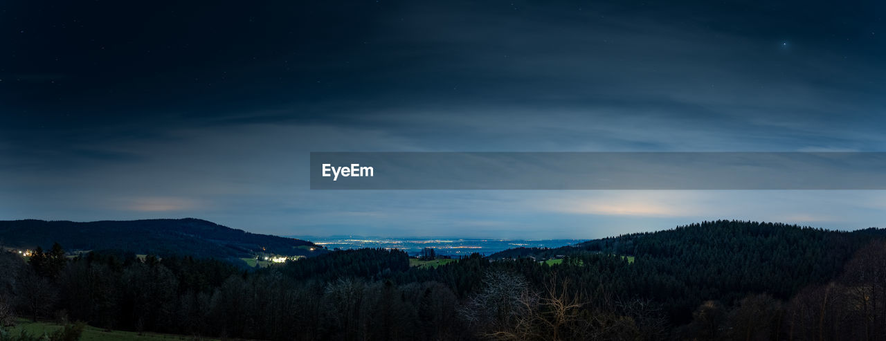 sky, scenics - nature, mountain, beauty in nature, environment, night, star, landscape, cloud, tree, plant, nature, land, dawn, tranquility, tranquil scene, astronomy, forest, space, mountain range, no people, non-urban scene, pine tree, horizon, blue, darkness, outdoors, evening, coniferous tree, idyllic, pinaceae, travel destinations, pine woodland, dramatic sky, galaxy, illuminated, winter, dark