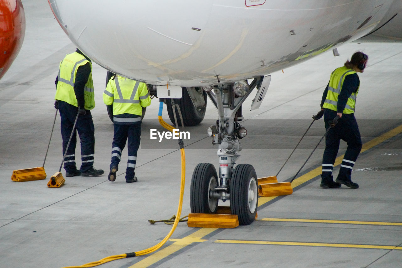 Low section of workers walking at runway