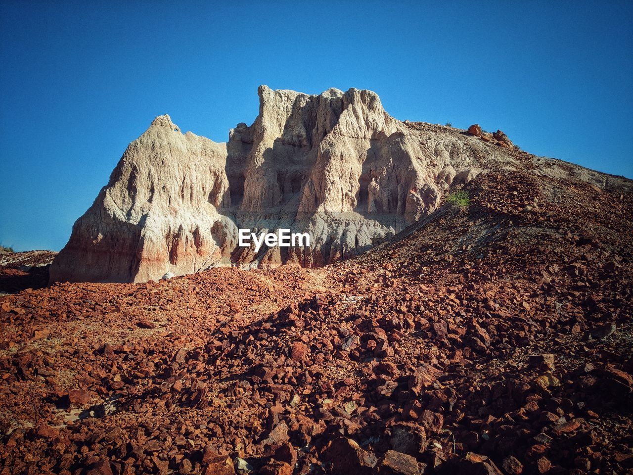 ROCK FORMATIONS ON LANDSCAPE AGAINST BLUE SKY