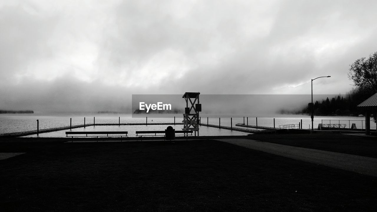 View of calm beach against clouds