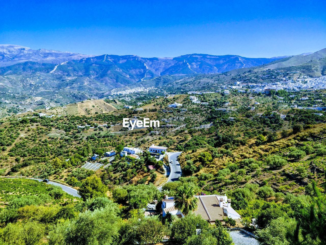 High angle view of trees and buildings against sky