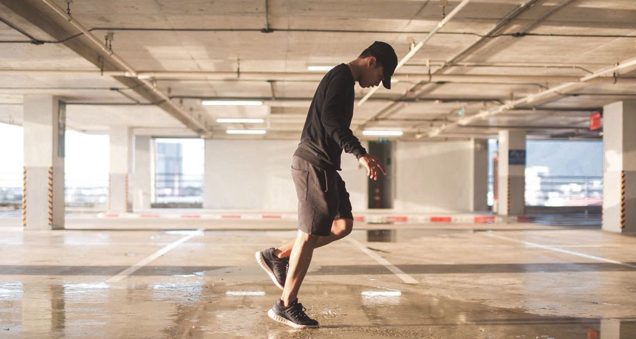 Full length of man standing in parking lot