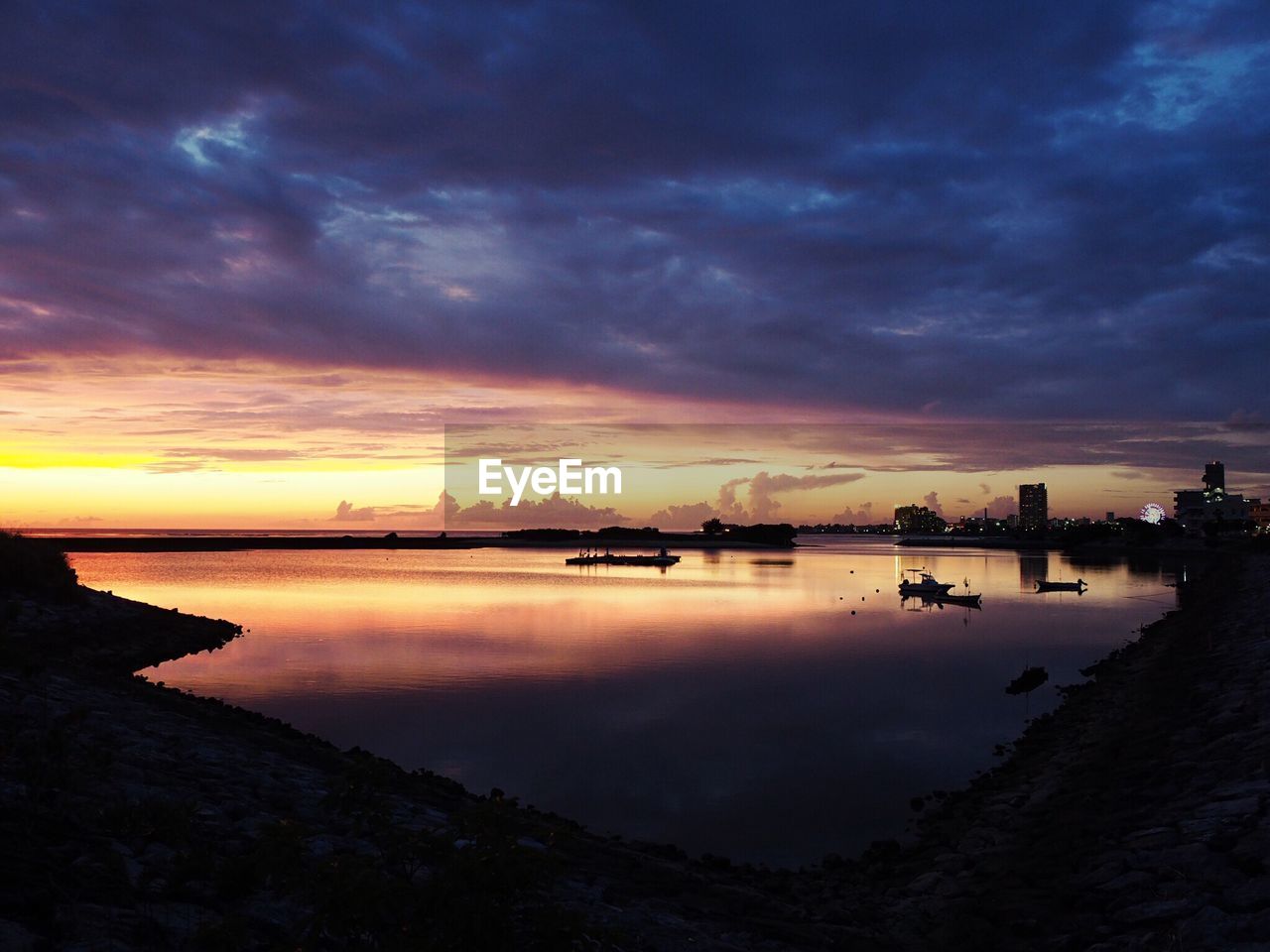 View of lake against cloudy sky during sunset