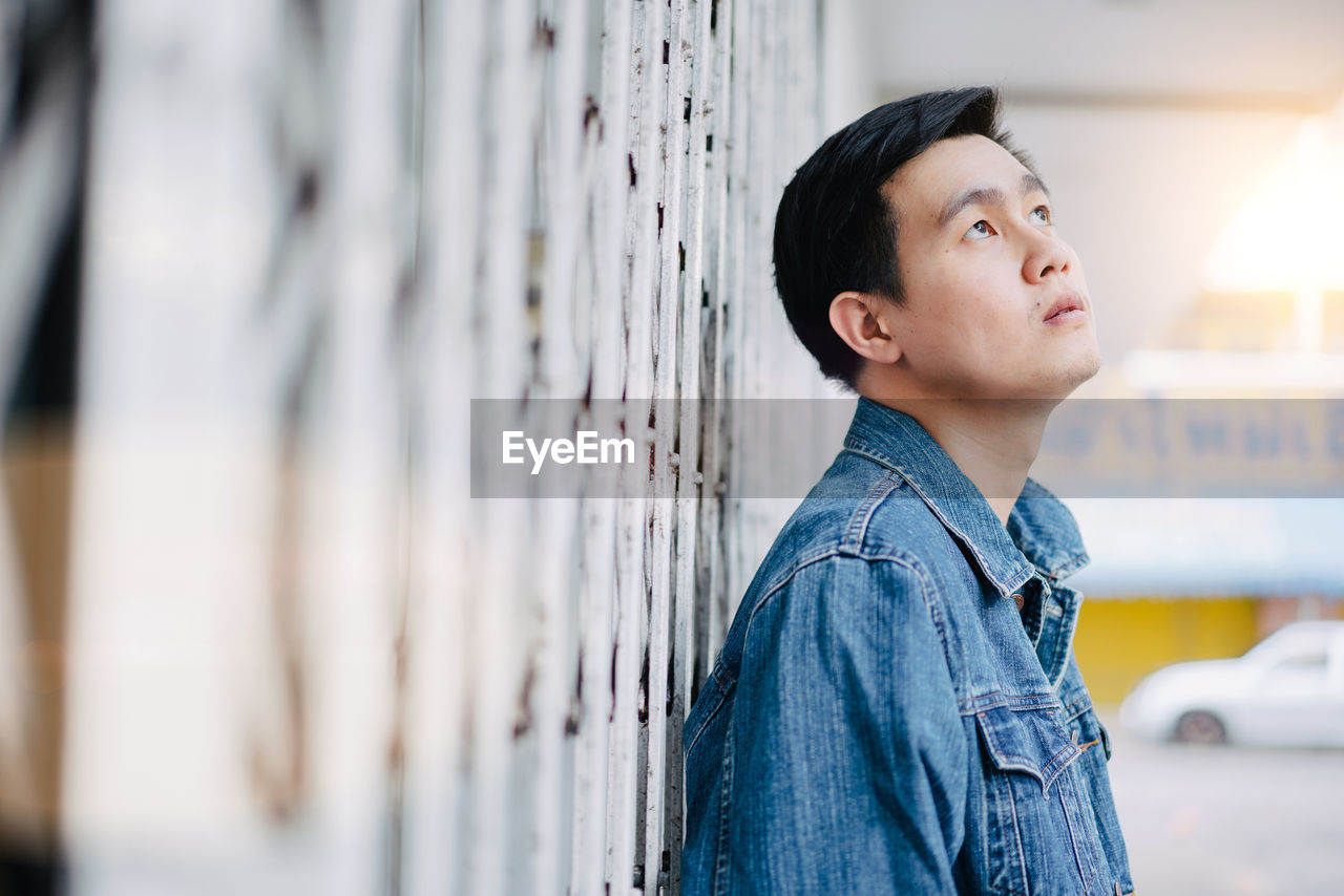 Man looking away against shutter