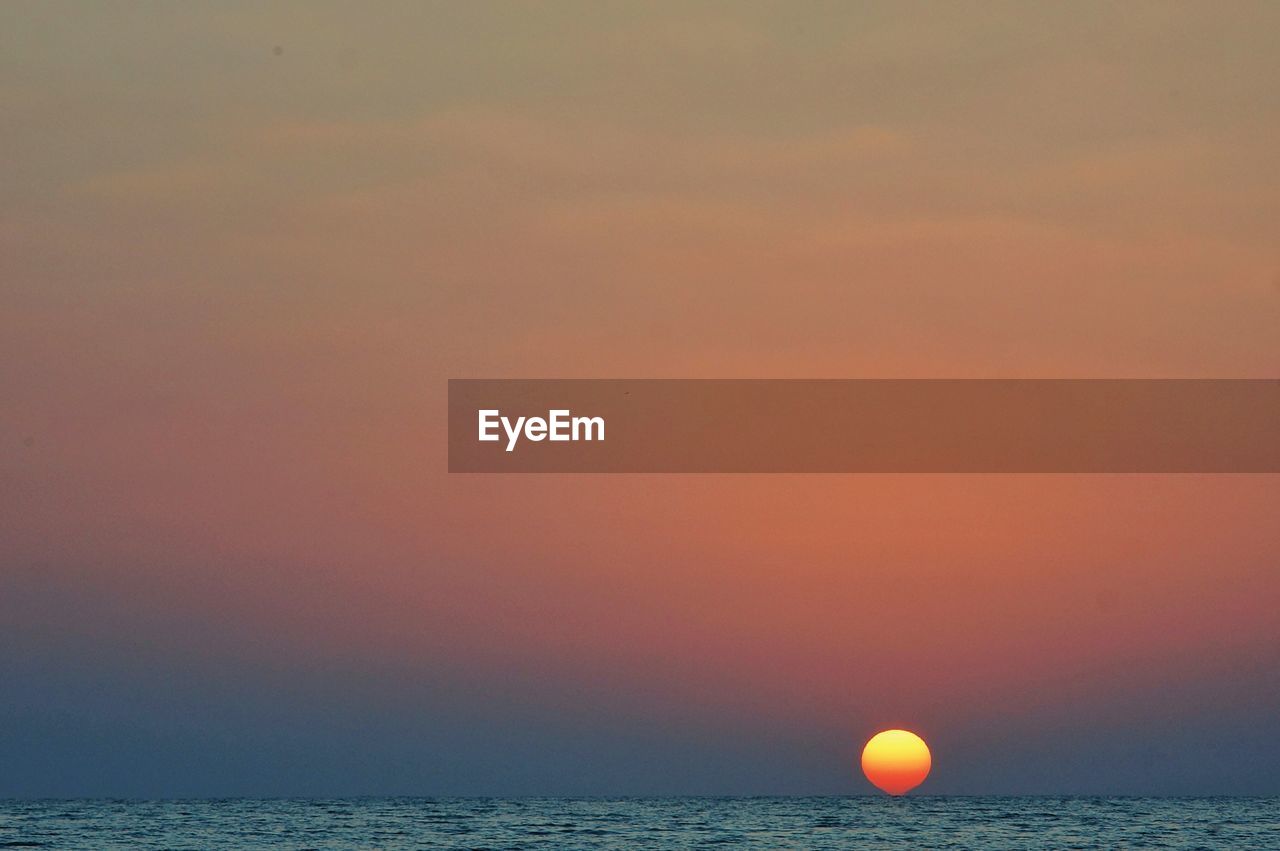 Scenic view of sea against sky at sunset