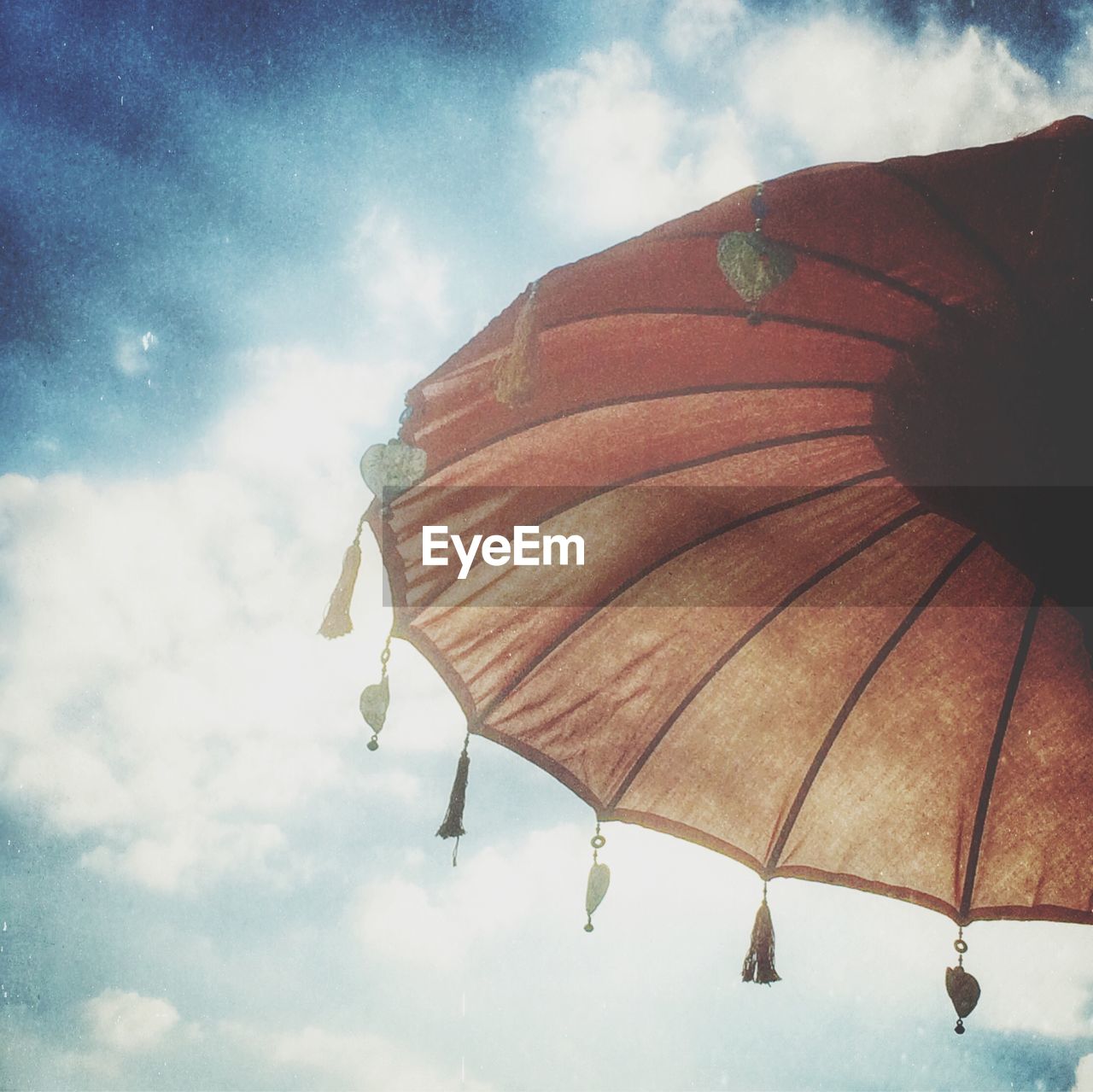 View of parasol against cloudy sky