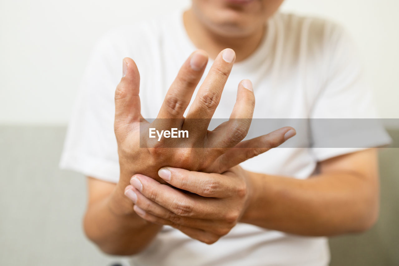 CLOSE-UP OF BOY WITH HAND ON FINGER