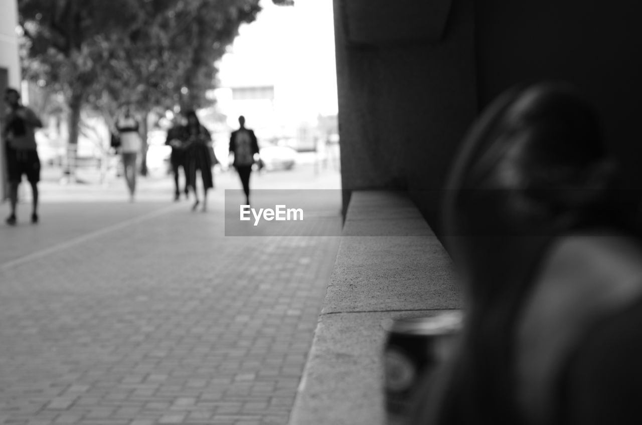 REAR VIEW OF WOMEN WALKING ON STREET