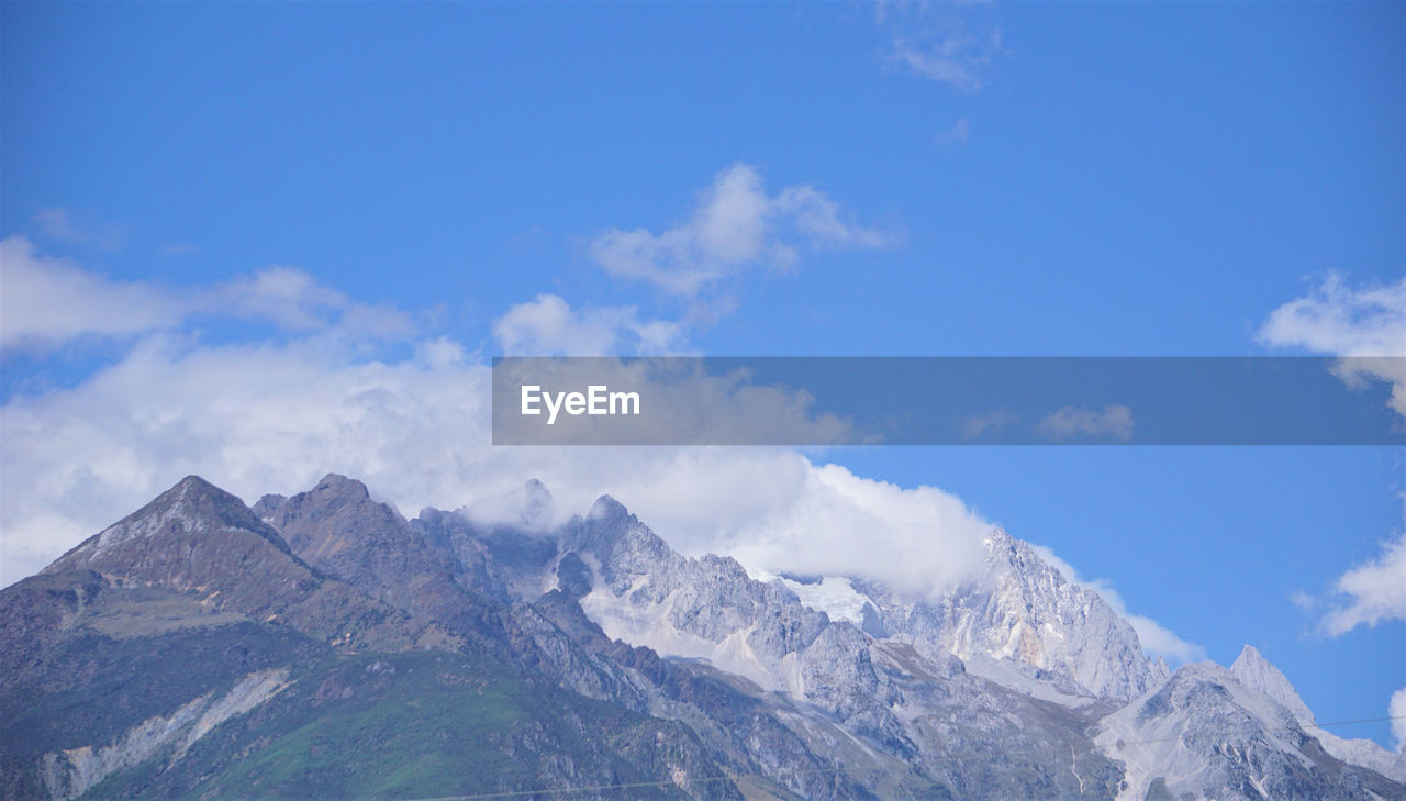 SCENIC VIEW OF MOUNTAINS AGAINST BLUE SKY