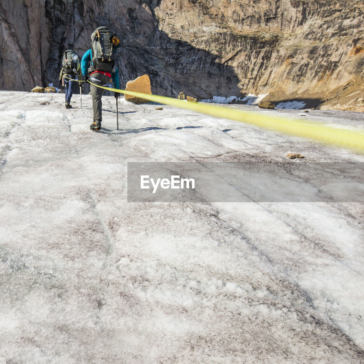 Climbing team on the move, ascending mountain summit.