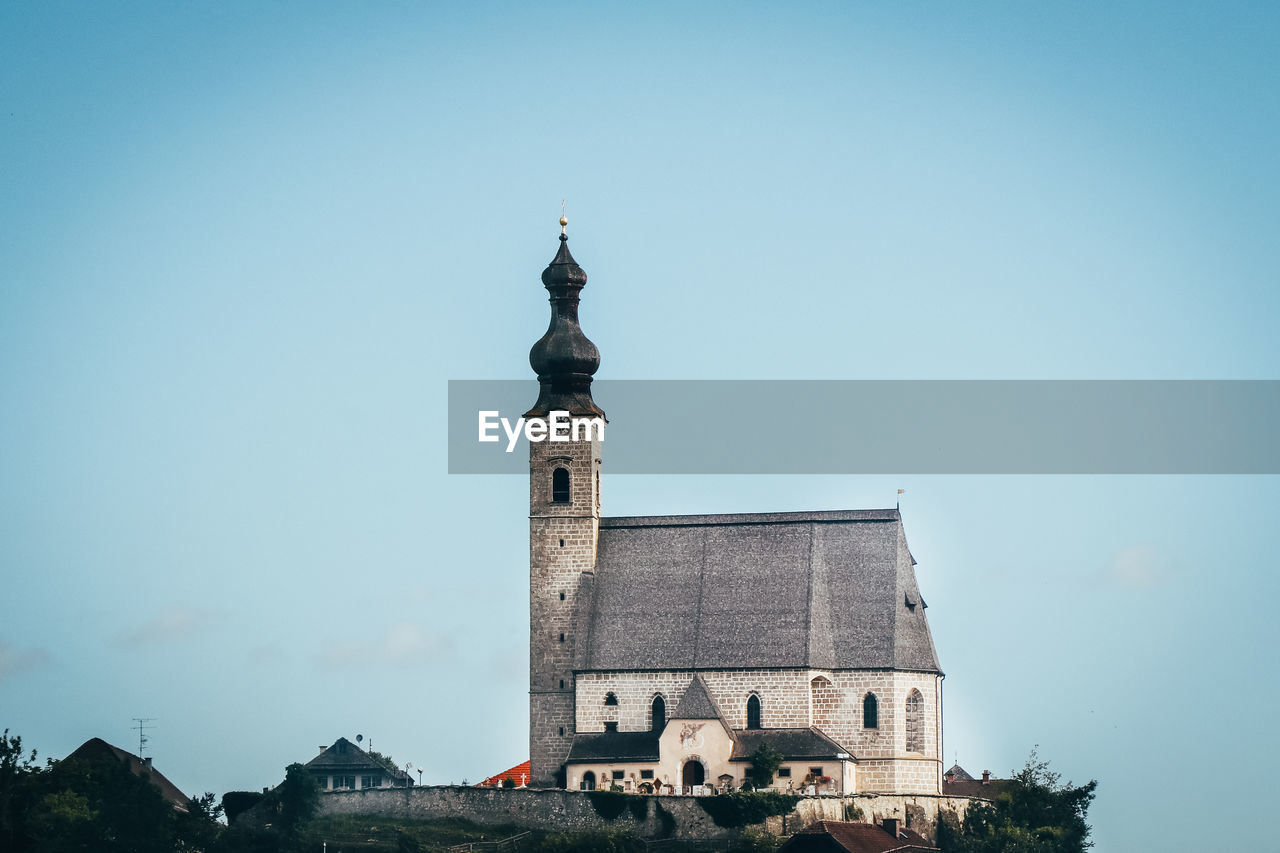  christian church on a raised rock as a dominant feature of christianity in the austrian lands