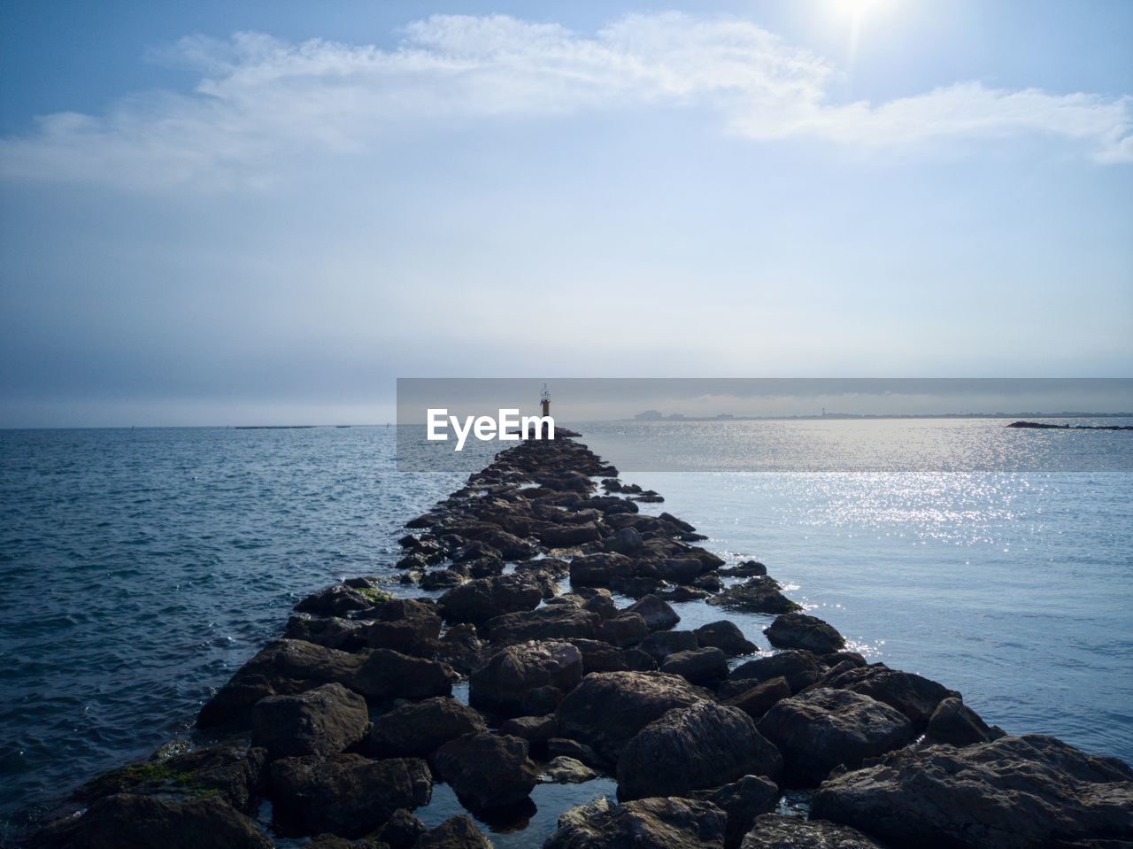 SCENIC VIEW OF ROCKS ON SEA AGAINST SKY