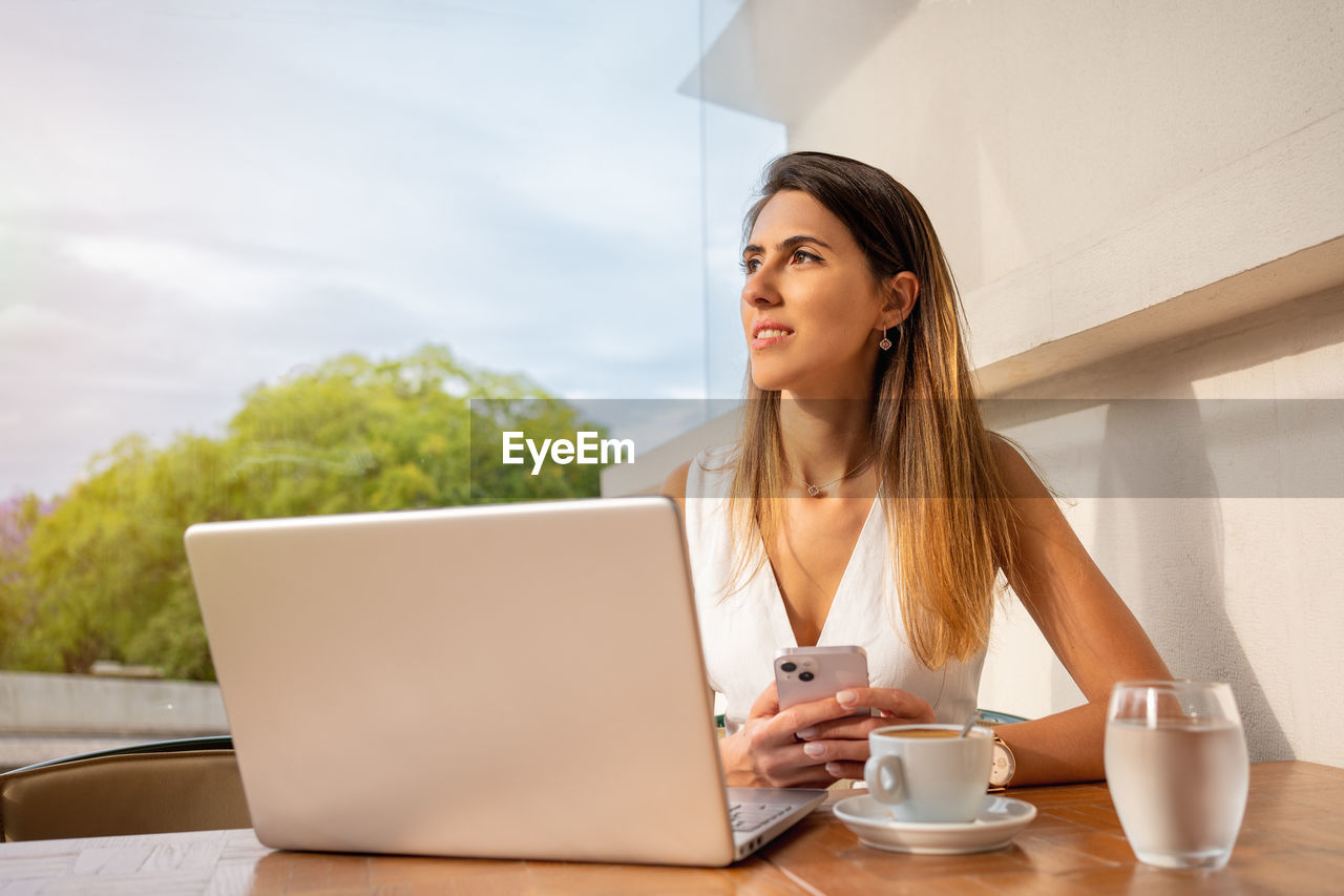 young woman using laptop while sitting at home