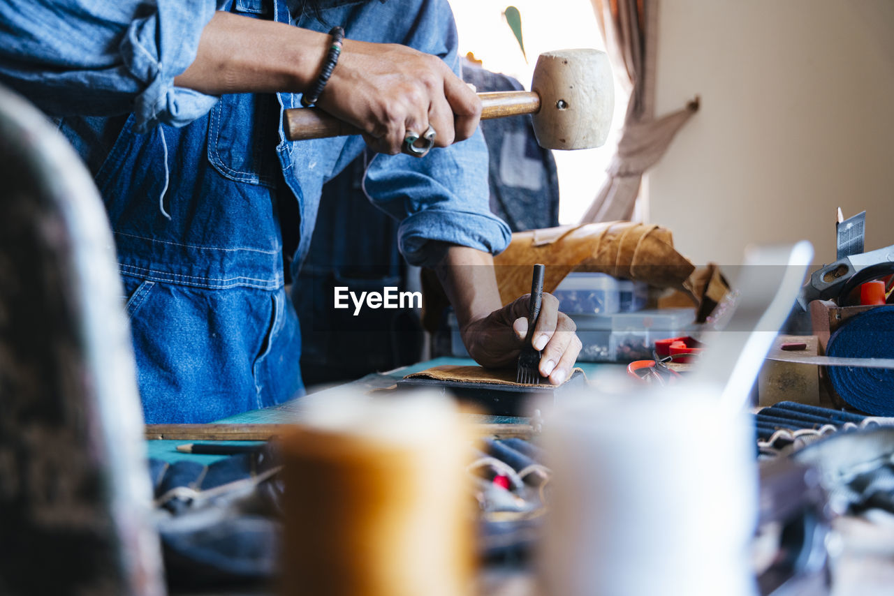 Side view of man working on table